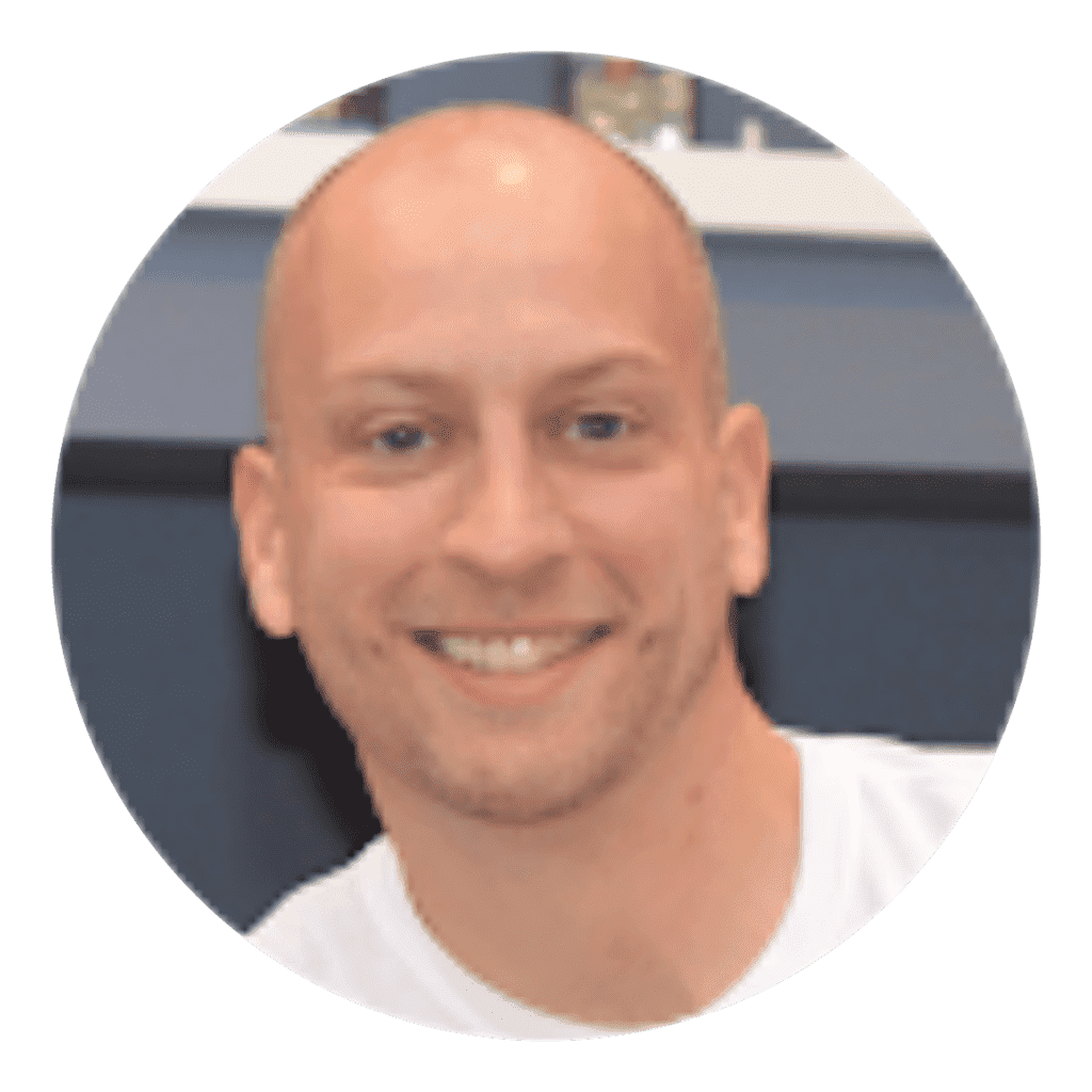 A man with bald head smiling for the camera.