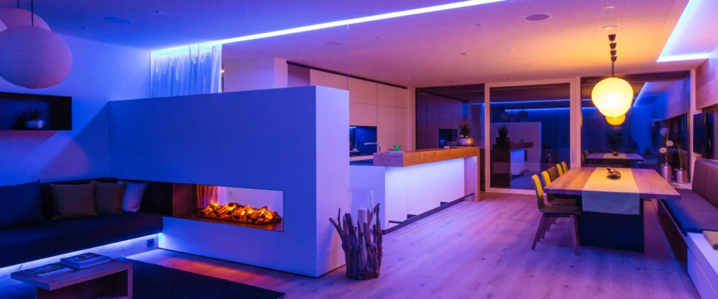 A room with a fireplace and lights on the ceiling