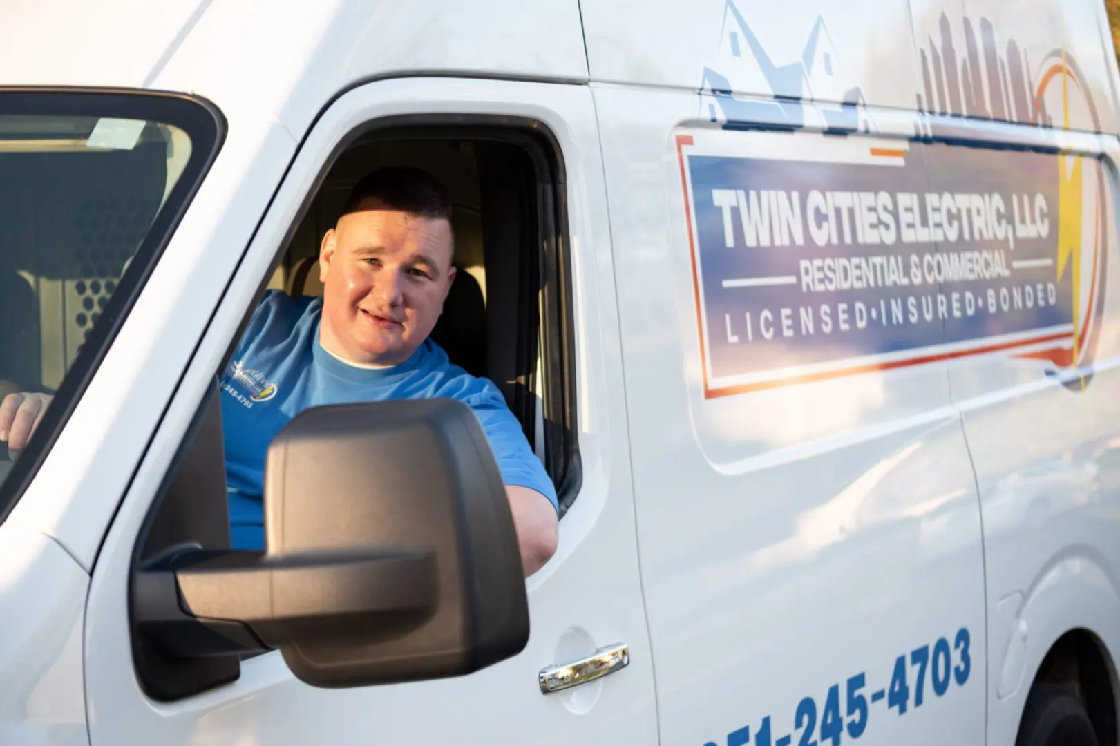 A man driving a truck in the back of it.