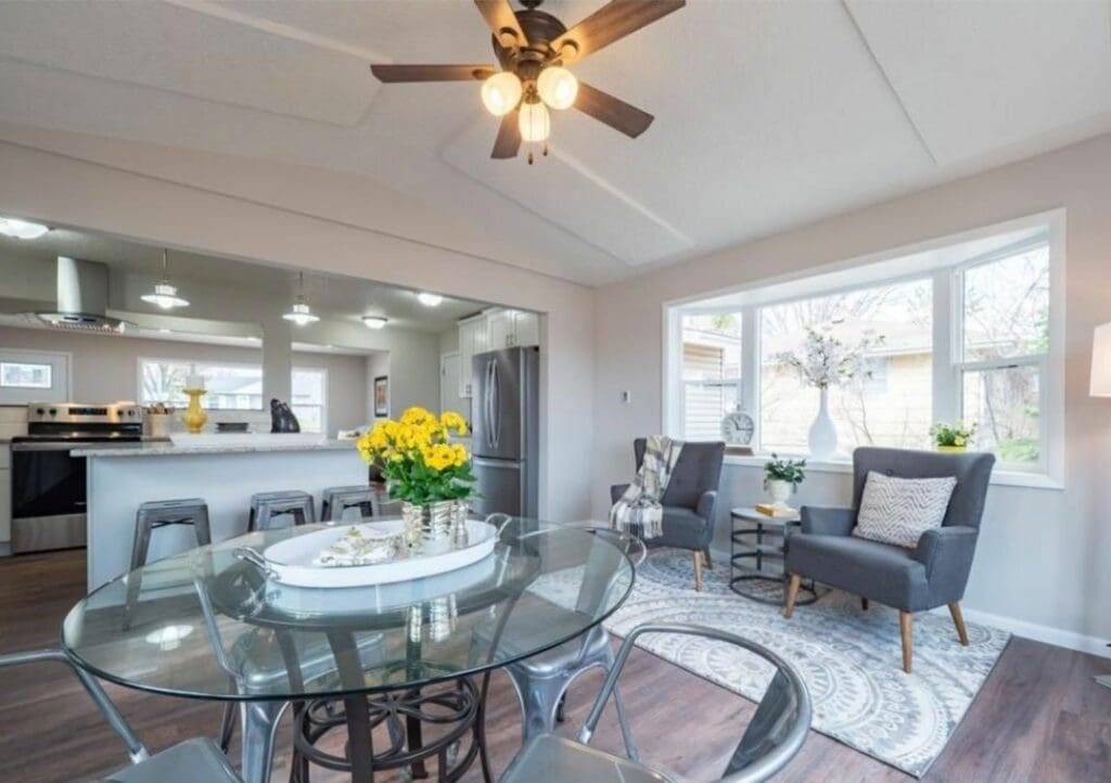 A living room with a glass table and chairs