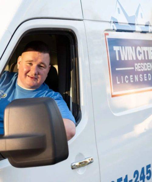 A man driving a truck in the back of it.